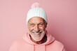 Portrait of a grinning man in his 50s dressed in a warm ski hat against a solid pastel color wall. AI Generation
