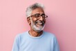 Portrait of a happy indian man in his 80s showing off a thermal merino wool top against a solid pastel color wall. AI Generation