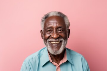 Wall Mural - Portrait of a happy afro-american elderly 100 years old man wearing a rugged jean vest against a solid pastel color wall. AI Generation