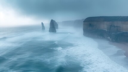 Canvas Print -  a large body of water next to a cliff with a large rock formation in the middle of the ocean on a foggy, overcast, overcast day.