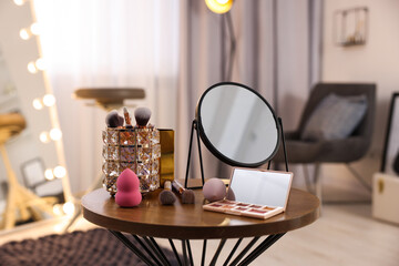 Canvas Print - Different beauty products and mirror on wooden table in makeup room