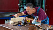 © Jack Tamrong - Expertise carpenter man working with diy wood plank in carpentry work place