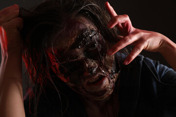 Wall Mural - Scary zombie on dark background, closeup. Halloween monster