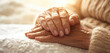 Gentle Hands Holding in Palliative Care. Elderly and caregiver hands in a comforting embrace on a cloth.