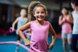 © Markus Schröder - Portrait of an active kid female doing resistance band exercises in a gym. With generative AI technology
