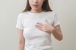 © KMPZZZ - Acid reflux disease, suffer asian young woman have symptom gastroesophageal, esophageal, stomach ache and heartburn pain hand on chest from digestion problem after eat food, Healthcare medical concept