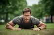 © Markus Schröder - Portrait of a satisfied boy in his 30s doing push ups outdoors. With generative AI technology