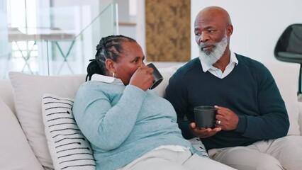 Wall Mural - Love, coffee and senior couple relax on sofa with conversation, gossip or bonding at home together. Happy, retirement and African old people in living room for communication, support or chat with tea