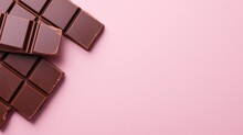 Dark Chocolate On Pink Background. Top View
