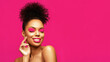 Leinwandbild Motiv Creative art make up beauty portrait. Overjoyed African American Fashion Model posing with a chin look against pink background. Satisfied Brunette young woman with afro curly bun hair style