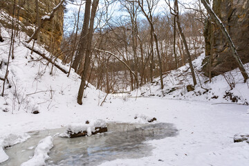 Hiking trail in Ottawa canyon on a brisk winter morning with snow covered landscape.  Starved Rock State Park, Illinois, USA.