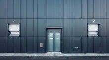Details Of Gray Facade Made Of Aluminum Panels With Doors And Windows On Industrial Building