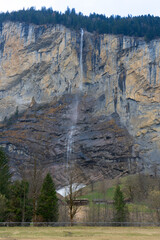 Wall Mural - a village and a mountain with a waterfall