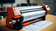Professional large format plotter printing wide design blueprints at engineering office