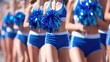 Cheerleading squad in blue uniforms with pom-poms