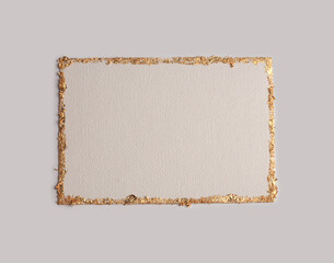 Beige and Gold glitter empty canvas frame card on gray paper background. Abstract copy space texture.