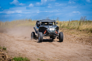 UTV buggy and 4x4 off road vehicle in sandy track. Buggy extreme riding