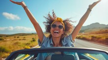 Joyful woman with arms raised in a convertible car, sunny day