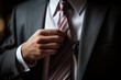 businessman adjusting tie