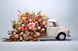© Milky Way - White retro truck car with trunk full of beautiful colorful different spring flowers. Moving to the right. Light blue background. Romantic flower delivery for Valentine day February 14