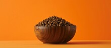 Dry Dog Food Placed In A Wooden Bowl With An Orange Backdrop.