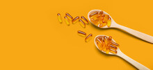 Spoons With Fish Oil Capsules On Orange Background With Space For Text
