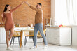 © Pixel-Shot - Happy young couple dancing in kitchen
