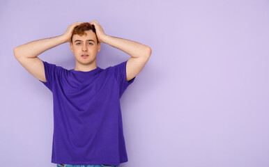Wall Mural - Stressed young man in purple t-shirt on lilac background