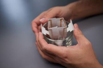 brewing process,a bag filled with boiling water for drip coffee in a cup,top view.