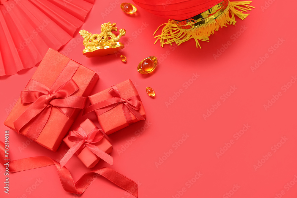Gift boxes with Chinese symbols on red background. New Year celebration