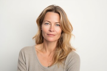 Wall Mural - Portrait of a beautiful middle aged woman with long blond hair on a white background