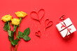 Leinwandbild Motiv Composition with rose flowers, paper hearts and gift box for Valentine's Day celebration on red background