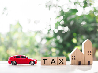 Wall Mural - Miniature house, Toy car and wooden blocks with word TAX. The concept of payment tax for car and house