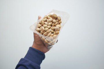 Poster - top view of pistachios nut on hand