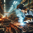 © itnozirmia - A man working with sparks in a factory industrial manufacturing