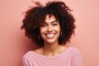© Inigo - Portrait of a beautiful young african american woman smiling against pink background
