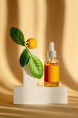 Wall Mural - Serum is orange in transparent glass bottle with white dropper lid on white podium-stand. Mockup of essential oil for care of women's skin on brown background, in rays of sunlight. Vertical frame