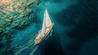 Top-down perspective of a sailboat navigating through body of water