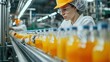 © Jennifer - Female worker inspects bottled fruit juice on beverage factory conveyor belt for quality control
