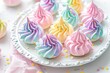 Multicolored meringue cookies with unicorn theme on a white plate
