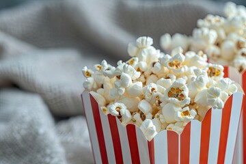 Two plain white popcorn boxes filled to the brim with popcorn