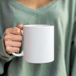 © Salander Studio - hand holding a white blank ceramic mug - mockup design template