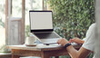 © Lek - Freelance work concept. a man using laptop working part time online and have coffee at outdoor cafe in summer