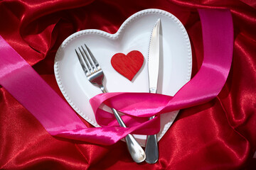 Canvas Print - Heart plate with silverware of fork and knife tied up on pink ribbon with a red heart