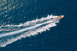 © aapsky - High speed boat rushing along the water surface of warm tropical waters, transfer of tourists. Aerial top view above