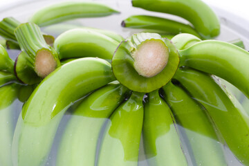 Wall Mural - Raw green bananas soaking the bananas in water. Cleaning fruits