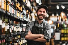 Portrait Of A Smiling Male Worker Standing With Arms Crossed In A Wine Store