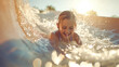 Happy young girl kid sliding down a water slide during summer holidays having fun doing outdoor activities