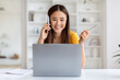 © Prostock-studio - Asian freelancer woman discussing work on phone call and using laptop