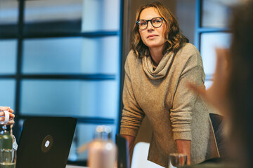 Wall Mural - Professional business woman leading creative team in tech startup office